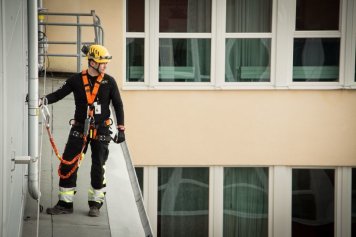 Výškový pracovník stojaci na streche